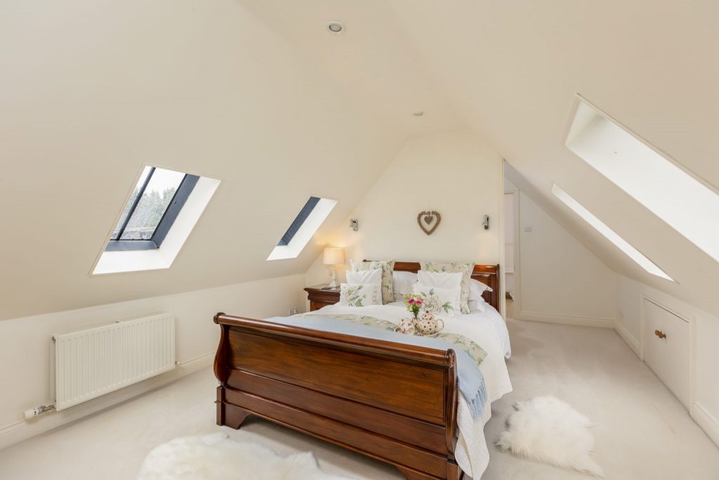 The Master Suite — stone walls and linen bedding