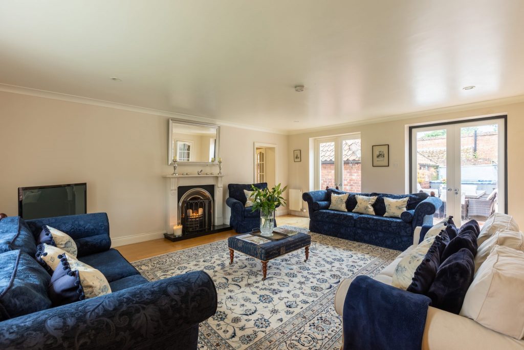 The Snug — leather armchairs by the fireplace